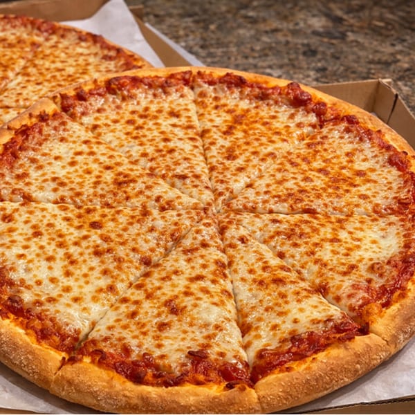 Two large, sliced cheese pizzas in cardboard boxes, with golden crusts and melted, bubbly cheese.