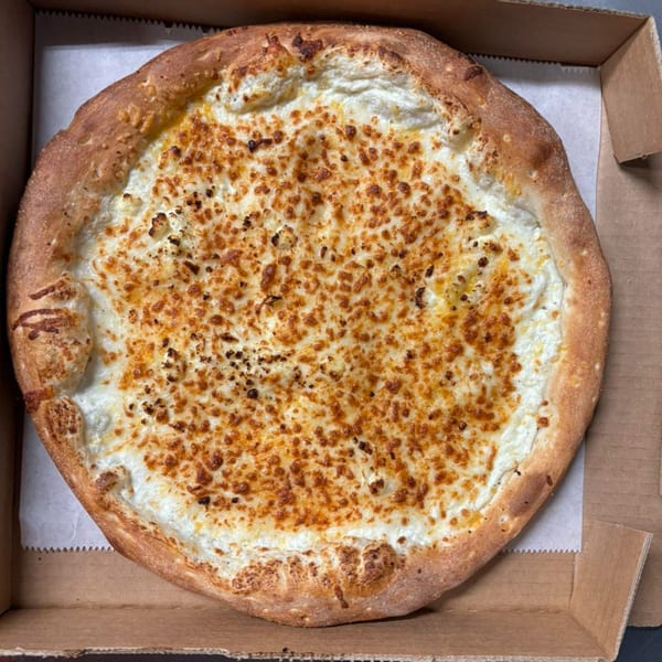 A white pizza with a golden-brown crust and melted cheese, in a cardboard box.