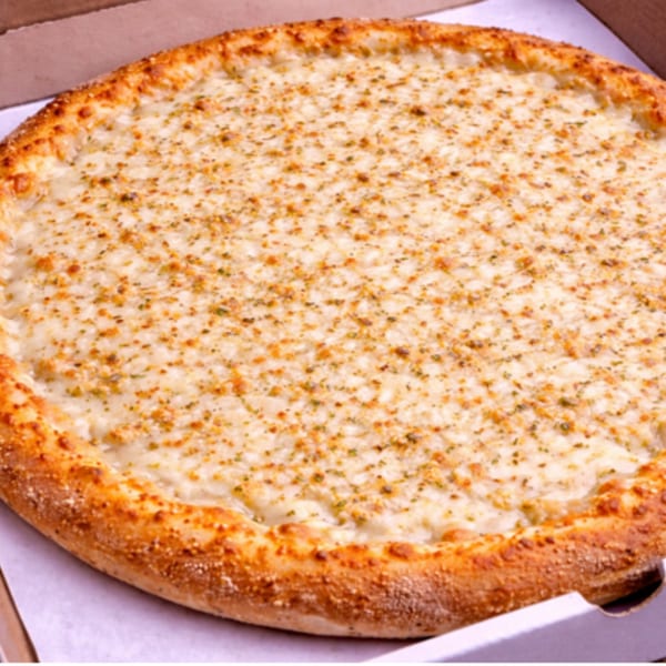 A whole white pizza with a golden crust, topped with cheese and herbs, in a pizza box.